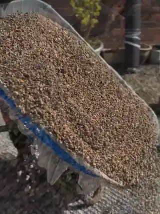 Golden aggregate tipping out of a wheelbarrow