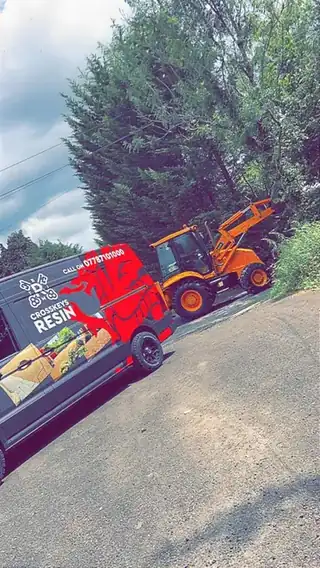 The Crosskeys Resin tipper parked on a valley road with the digger loaded