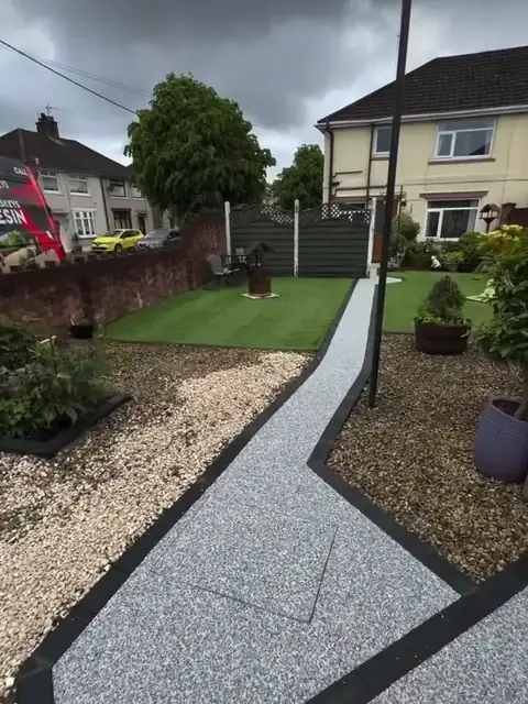 The finished silver path curving through the lawn towards the house