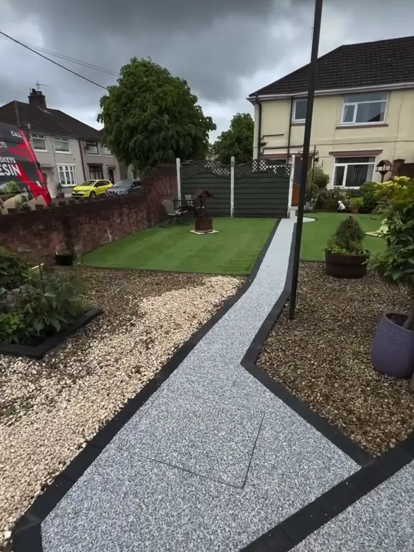 The finished silver path curving through the lawn towards the house