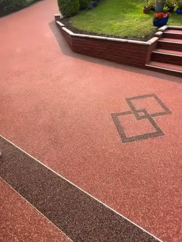 Two interlocking squares inlaid in dark aggregate in the terracotta resin